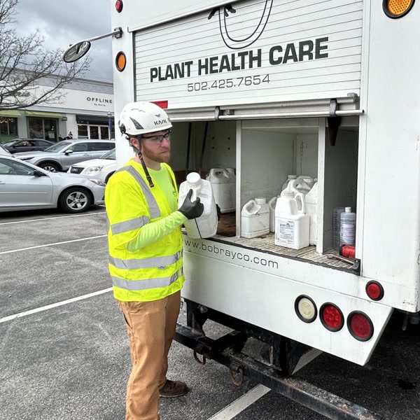 Austin Grayson, plant health care specialist, at a Bob Ray Plant Health Care truck